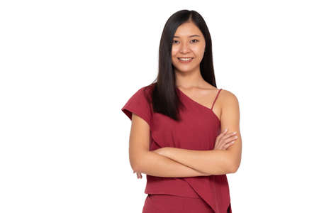 Portrait of young asian woman with arms crossed and looking at camera isolated on white backgroundの写真素材