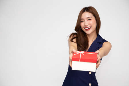 Happy beautiful Asian woman smile with red gift box isolated on white background. Teenage girls in love, Receiving gifts from lovers. New Year, Christmas and Valentines Day conceptの写真素材