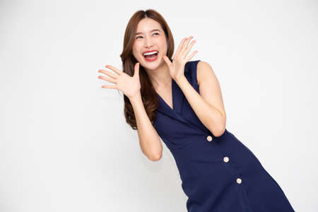 Young beautiful Asian woman surprise and delight isolated over white background, Thrilled excited conceptの写真素材