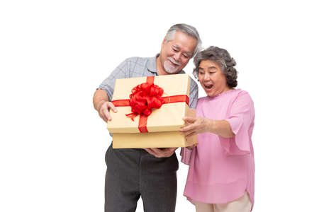 Senior Asian couple opening gold gift box with ribbon bow isolated on white background, Elderly...