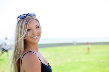 Young woman wearing sunglasses posing at the parkの写真素材