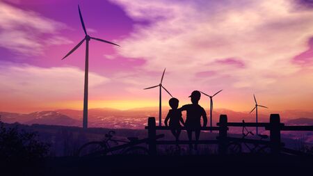 Two boys at sunset look at wind turbinesの写真素材