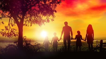A family with children on a bike ride stopped by the riverの写真素材