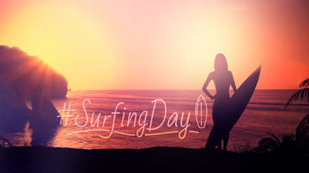 Silhouette of a girl with a surfboard on a sunset background.の写真素材