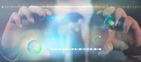 A man holds a gadget of the future in his hands.の写真素材