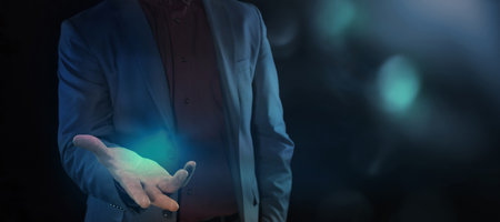 Businessman holding out his hand to show something.