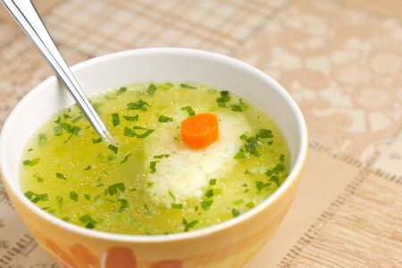 Soup with dumplings, carrot and parsleyの写真素材