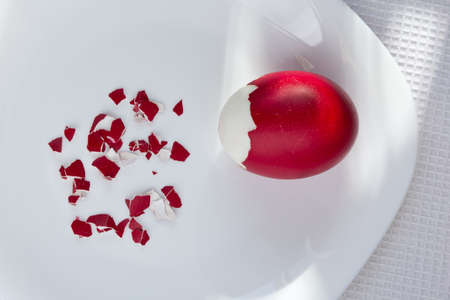 Red easter egg, broken, ready to eatの写真素材