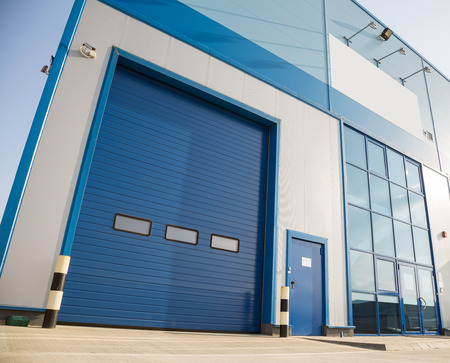 Modern industrial building with big blue garage door
