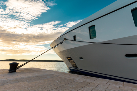 Private luxury yacht anchored in the harbor at sunrise ready for the tripの写真素材