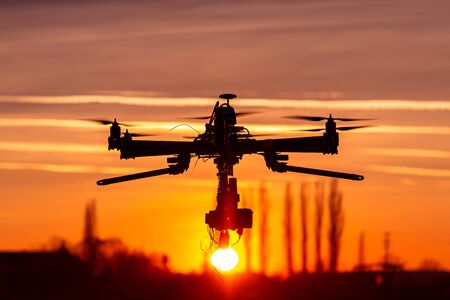 Professional drone silhouette in the sunset red sky