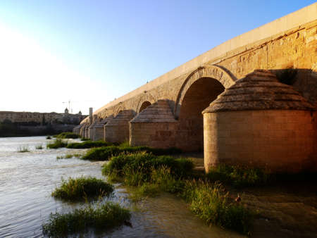 Roman Bridge of CÃ³rdoba, which joins the two banks of the city separated by the Guadalquivir river, measuring 331 meters and with perfectly preserved archesの写真素材