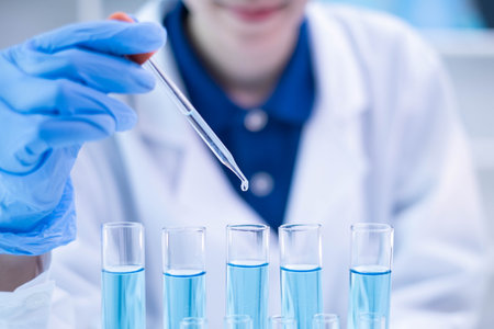 Professional scientist chemist technician analysis research experiment virus blue liquid pipette glass test tube equipment in hospital laboratory, woman doctor white lab coat medical research developの写真素材