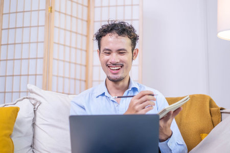 Professional businessman person hand pen writing on notebook paperwork with laptop indoor desk workplace home, adult entrepreneur business office man male note working computer internet technologyの写真素材