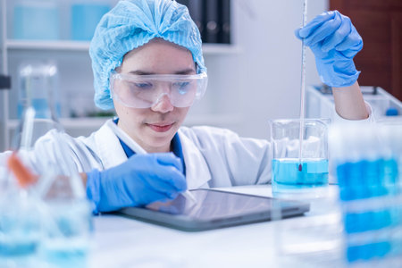 Professional woman specialist doctor laboratory white uniform use thermometer temperature on blue liquid in healthcare and medicine experiment equipment with glove care, young adult female scientistの写真素材