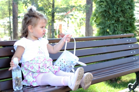 My daughter on a benchの写真素材