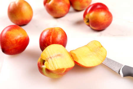 Cutting Nectarines on the kitchen table の写真素材