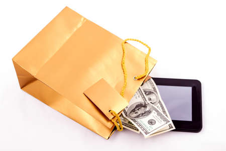 A gold gift bag with a Tablet PC and dollars isolated
の写真素材