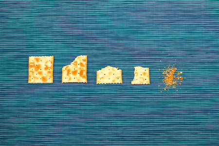 Salted crackers bitten process, backgroundの写真素材