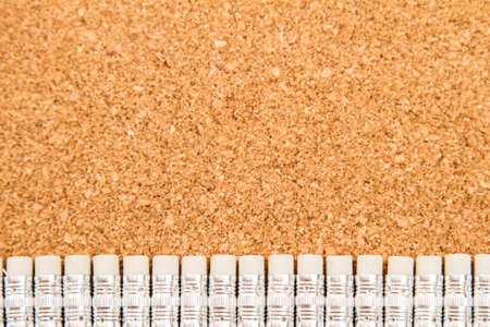  Bunch of pencils with rubbers over a cork boardの写真素材