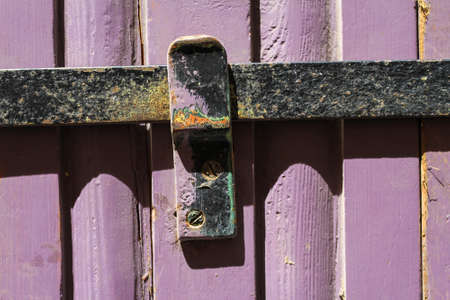 Old door with an iron bar backgroundの写真素材