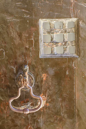 Old door with doorknocker backgroundの写真素材