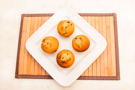 Vanilla with chocolate chips Muffins on a white plate の写真素材