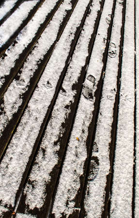 Snowy deck with several footprintsの写真素材