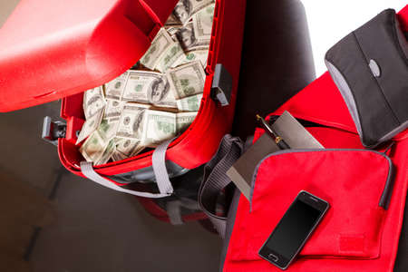 A Suitcase with lots of dollars, ready for business