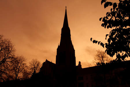 Silhouette of church dome in Berlin backlit by sunset colorsの写真素材