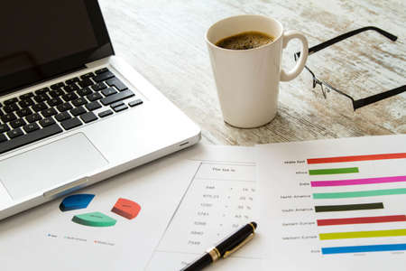 Working, analyzing graphics and doing calculationsの写真素材