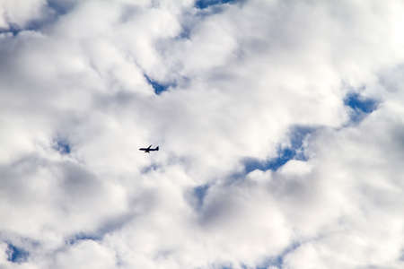 Airplane midair on a cloudy dayの写真素材