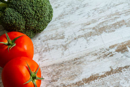 Tomatos and broccoli background with copy space