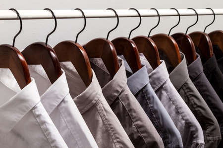 Several shirts on a hanger	 from white to black color rangeの写真素材