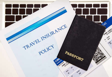 Travel insurance policy booklet with a boarding pass and a passportの写真素材