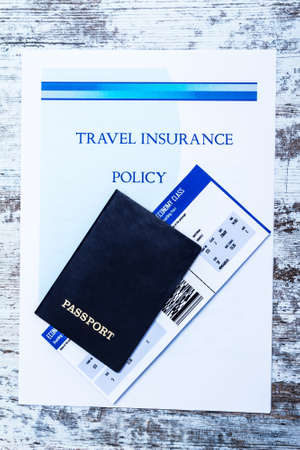 Travel insurance policy booklet with a boarding pass and a passportの写真素材