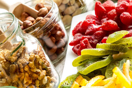 Selection of dried fruits in jars and on a plate
