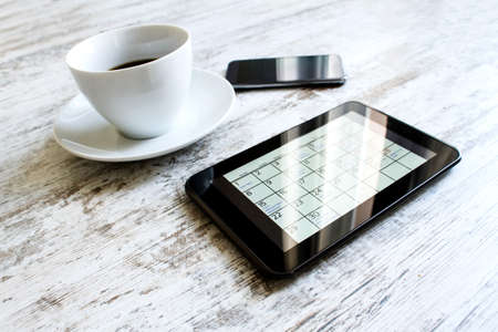 Checking monthly activities and appointments at the office in the tabletの写真素材