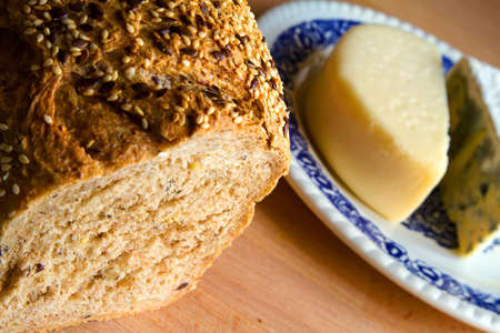 Delicious snack, bread, glass of red wine and cheese