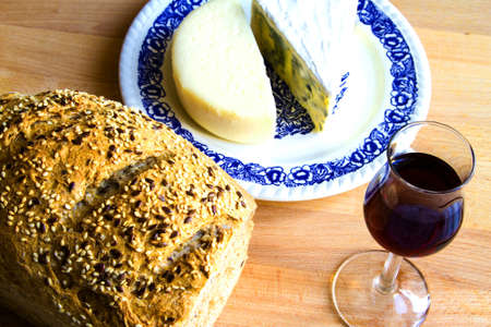 Delicious snack, bread, glass of red wine and cheeseの写真素材