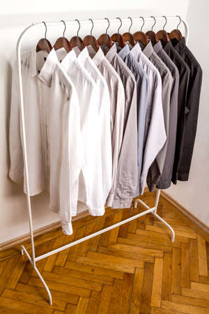 Several shirts on a hanger	 from white to black color rangeの写真素材