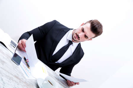 Working at the office with the laptop and some documentsの写真素材