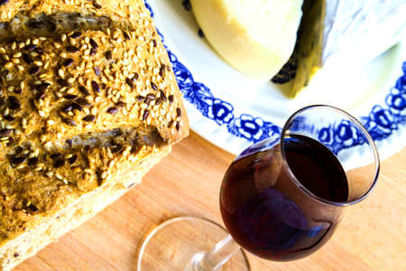 Delicious snack bread glass of red wine and cheeseの写真素材