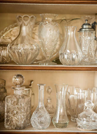 Antique glass vase on a china cabinetの写真素材