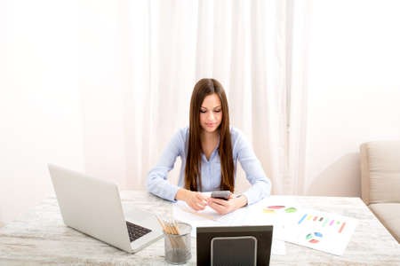 Businesswoman working at the office with the laptop and some documentsの写真素材
