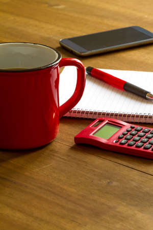 Working, taking notes and doing calculationsの写真素材