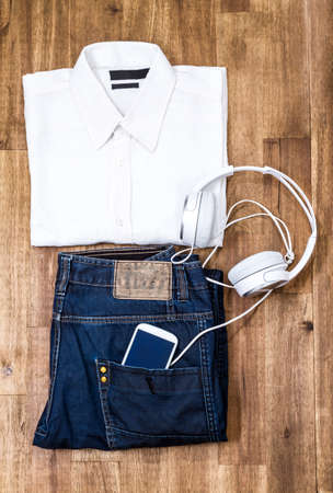 Informal male outfit with cellphone and headphone, backgroundの写真素材