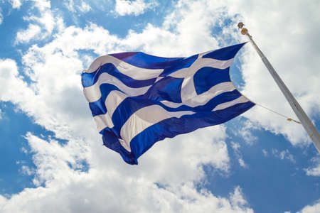 Greek flag waving in the skyの写真素材