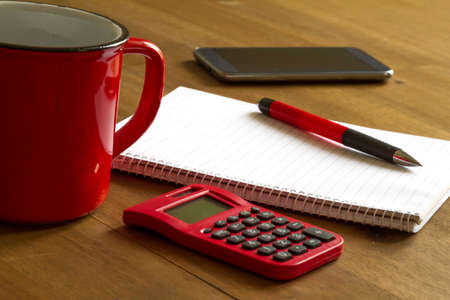 Working, taking notes and doing calculationsの写真素材