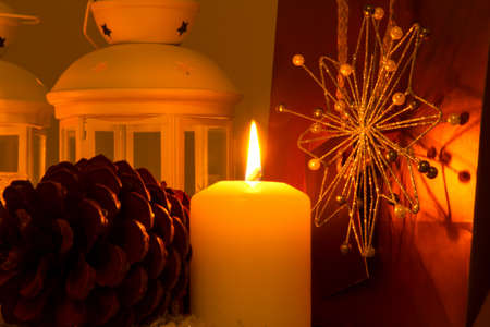Christmas setting with candles, pine cones, shopping bags and baubles.の写真素材